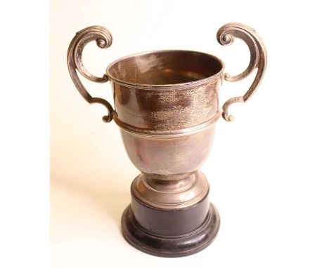 A George V silver trophy cup, having twin scrolling handles and banded decoration on a circular footrim, 12.9oz