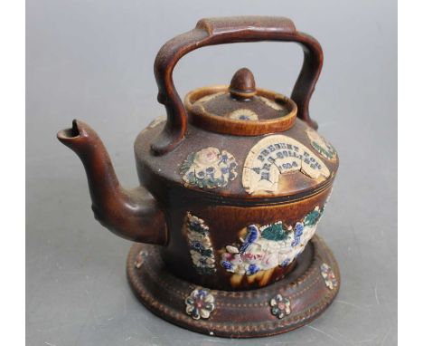 A late Victorian bargeware treacle glazed teapot and cover, having applied decorated of birds and flowers with plaque marked 