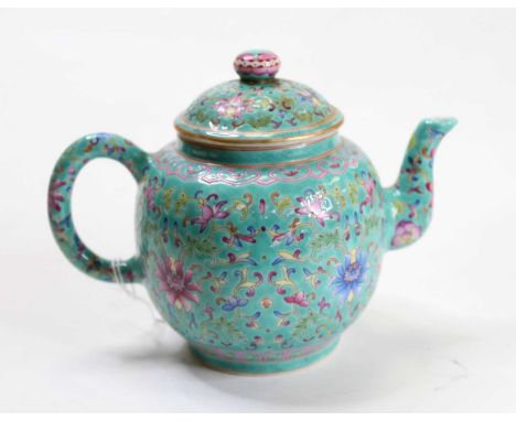 A Chinese export teapot, of bullet form, enamel decorated with lotus on a turquoise ground, four character mark to the unders