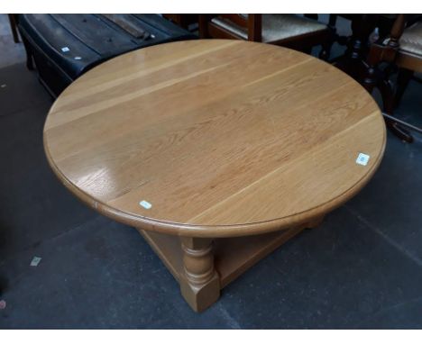 A modern round light oak coffee table 