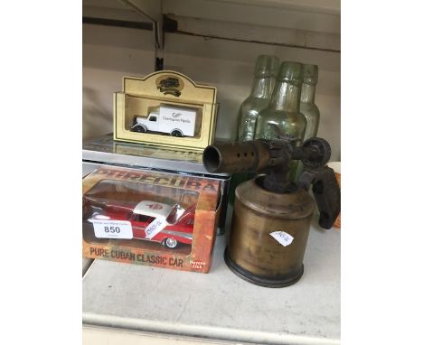 Model vehicles, blow lamp and some glass bottles 