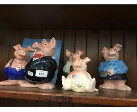 Five Nat West Wade pigs and statement holder 