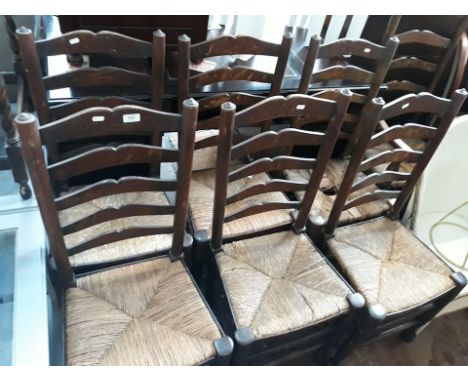 A set of 7 Ormskirk rush seated ladder back chairs 