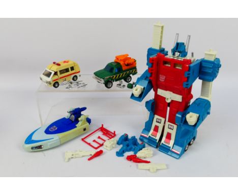 Transformers - A group of vintage Transformers, Ultra Magnus, Hoist, Ratchet and Scourge. They show some signs of age ad use 