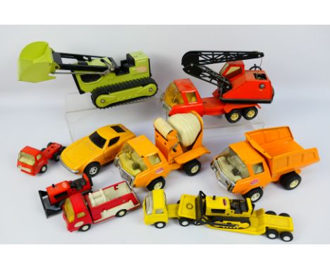 Tonka - A collection of vintage pressed steel vehicles including an excavator, cement mixer, dump truck, crane truck, a Datsu