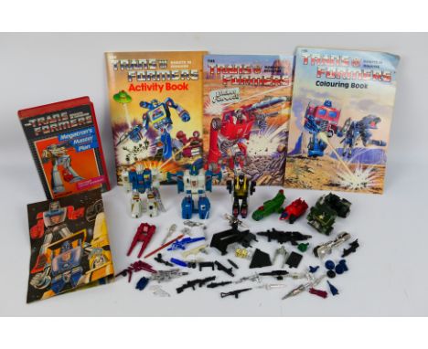 Transformers - A group of vintage Transformers including Hound, Topspin, Twin Twist and others and with a colouring book, sti