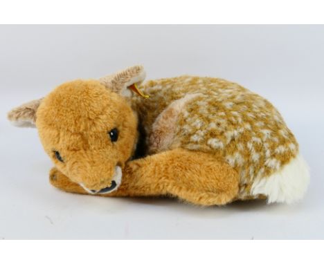 Steiff - A recumbent fawn by Steiff with yellow ear tag and gold button # 1831/38. Measures approximately 30 cm across and ap