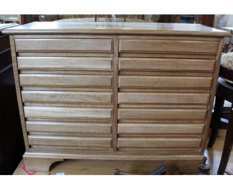 A modern light coloured office filing chest of fourteen drawers