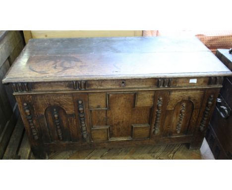 An 18th Century carved oak coffer with split bobbin turned mouldings