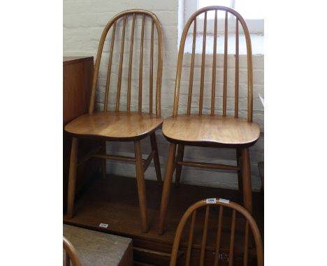 A set of four light Ercol style beech and elm hoop back chairs