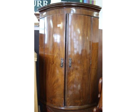 A 19th Century mahogany bow front hanging corner cupboard