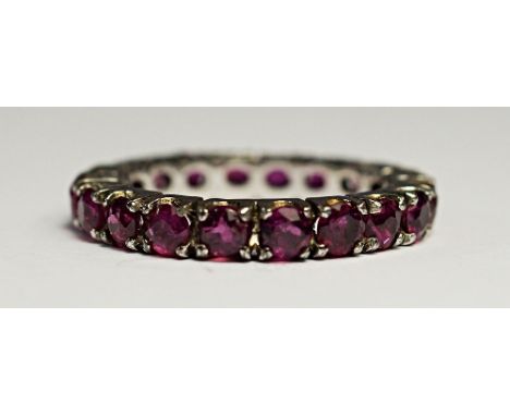A ruby eternity ring, set in white metal, approx size M, approx 2.9g.
Provenance: Property of a lady.  CONDITION REPORT: A fe