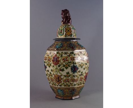 A Continental pottery hexagonal faceted baluster vase, possibly French, late 19th century, the lid mounted with a lion finial