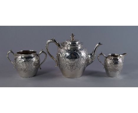 A Scottish silver three piece bachelor tea service, Glasgow 1908, James Reid & Co, embossed in the Aesthetic taste, comprisin