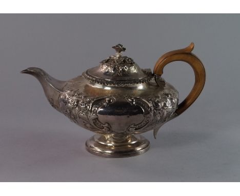 A William IV silver teapot, London 1835, Charles Thomas Fox, with leaf and floral finial to the floral embossed hinged cover,