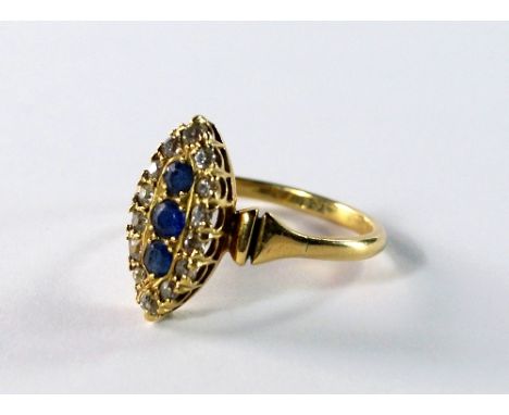 An 18ct gold, sapphire and diamond ring, of marquise form, three sapphires surrounded by old cut diamonds, approx size X, app