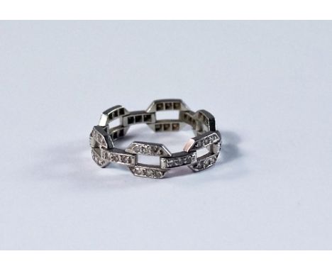 A white metal and diamond set ring, of articulated chain form, approx size M/N, approx 3.3g.  CONDITION REPORT: Good conditio