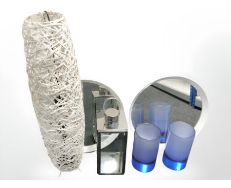 Two contemporary mirrors, a wicker floor lamp, a metal lantern and two vases.