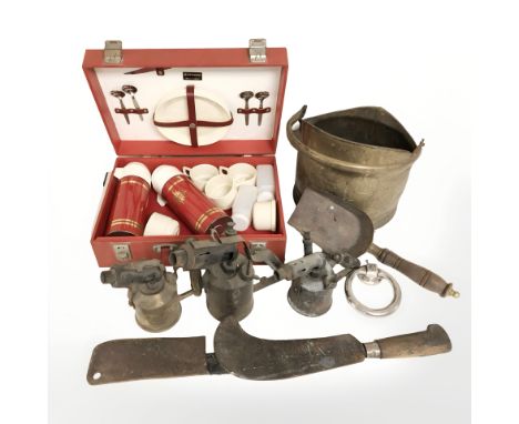 A Sirram picnic set, a group of blow lamps, Victorian brass coal scuttle, a scythe, etc. (2 boxes)