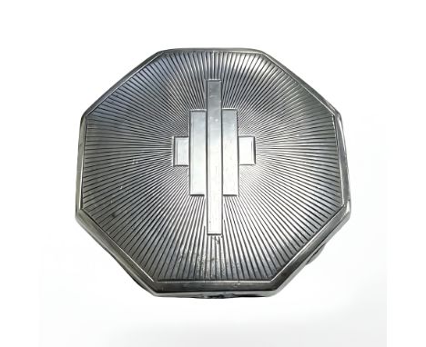 A silver engine turned powder compact.