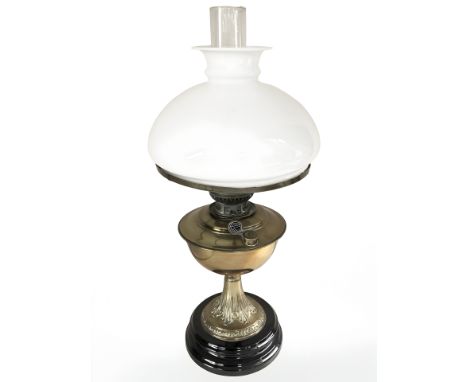 A Veritas brass oil lamp with opaque shade, height 55 cm.