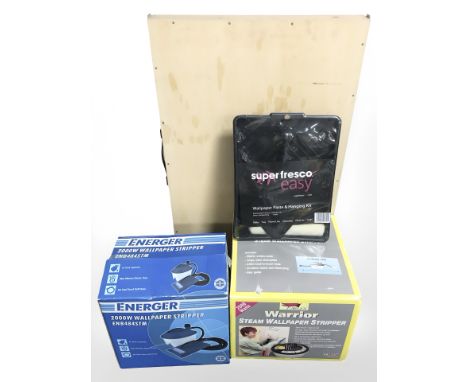 Two boxed wall paper strippers, roller trays, brush, ply wood pasting board 