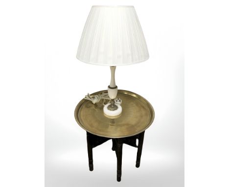 An Eastern bobbin turned folding occasional table with engraved brass top, diameter 57 cm, together with gilt metal and marbl