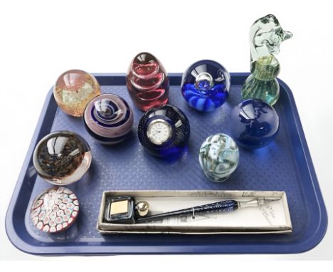 A group of glass paperweights, Caithness quartz timepiece paperweight and a Murano glass fountain pen with ink bottle.
