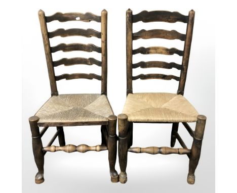 A pair of beech ladder back farmhouse chairs.