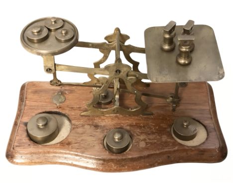 A set of Victorian oak and brass letter scales with graduated weights, width 24 cm.