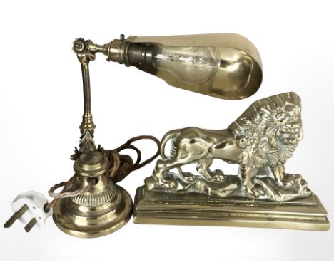 A Victorian cast brass lion doorstop, width 25 cm, together with an early 20th century brass adjustable desk lamp.