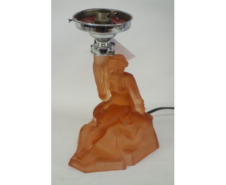 A rose coloured lamp base in the form a young lady in flowing dress seated on rock holding lantern aloft H 23cm Condition Rep