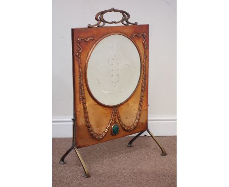 Arts and Crafts copper fire screen, embossed husk decoration, fitted with central bevelled glass mirror, raised on bracket fe