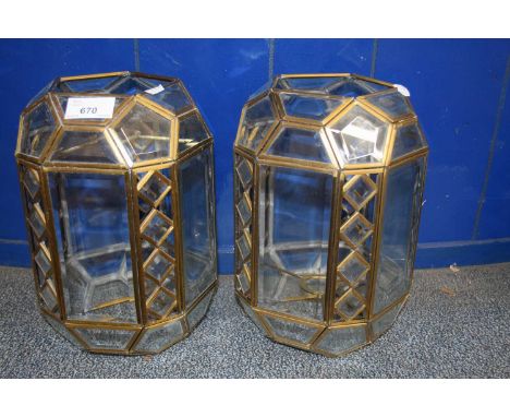 A pair of brass framed and clear glass ceiling light shades