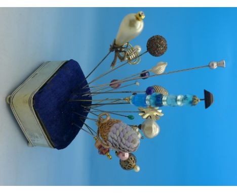 Twenty-three hat pins including vintage on a plated stand/box