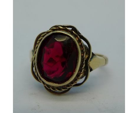 A 9ct gold and red stone ring, 3.2g, K