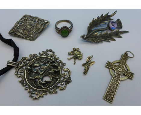 A large hallmarked Scottish silver thistle brooch set with a cabochon amethyst, 54mm, a Celtic cross pendant, a large 925 sil