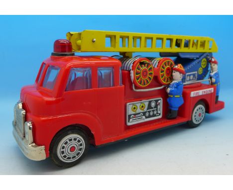 A friction drive tin-plate and plastic fire engine with pop-up ladder, 26cm