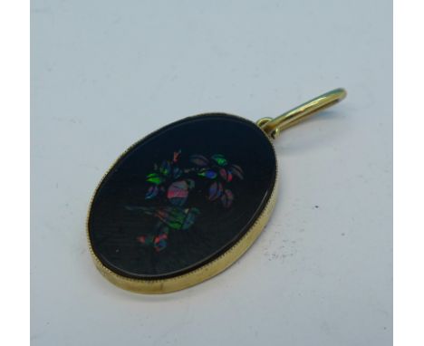 A 9ct gold mounted onyx and opal pendant