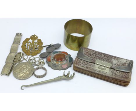 A small coin purse with silver embellishments, a silver bracelet, pendant and chain, RAF cap badge, trench art napkin ring, e