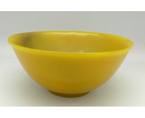 A Chinese 18th Century imperial yellow Peking glass bowl with reverted rim, some wear, diameter 162mm