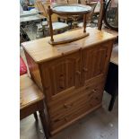 A pine linen cabinet with a rectangular top above two cupboards and two drawers together with an