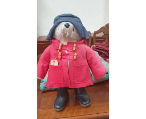 A Paddington bear teddy bear in a red jacket and Dunlop wellies