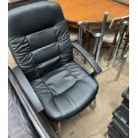 A black leatherette office chair together with a nest of two glass tables