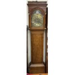A 19th century oak long case clock with a caddy top and three quarter columns above a long trunk