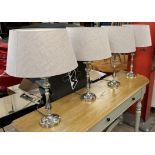 A set of four chrome table lamps