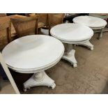 A set of three cream painted occasional tables on ribbed columns and a trefoil base and leaf carved