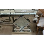 A mirrored side table with a rectangular top above a square base and crystal on a rectangular base
