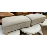 A pair of upholstered footstools on turned legs