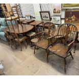 A Regency style mahogany dining table and five chairs together with a pair of wheel back Windsor